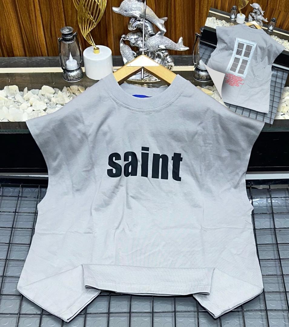 Gray oversized armless top with black saint text print on chest.