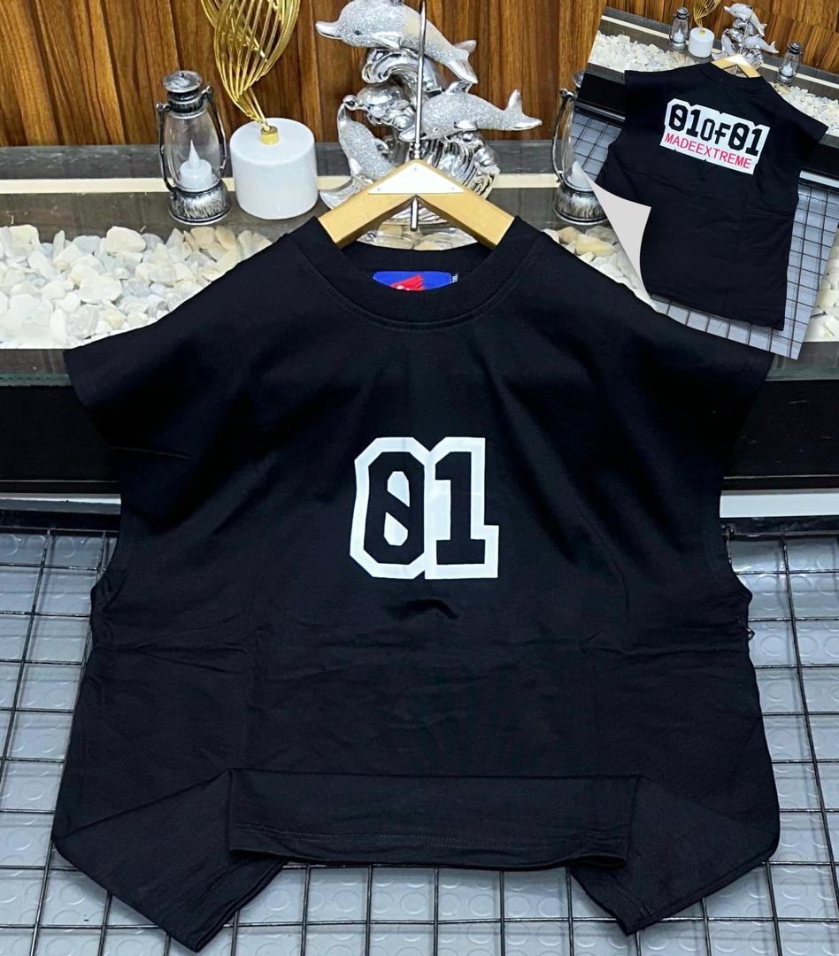 Black oversized armless top with large white 01 graphic on chest.