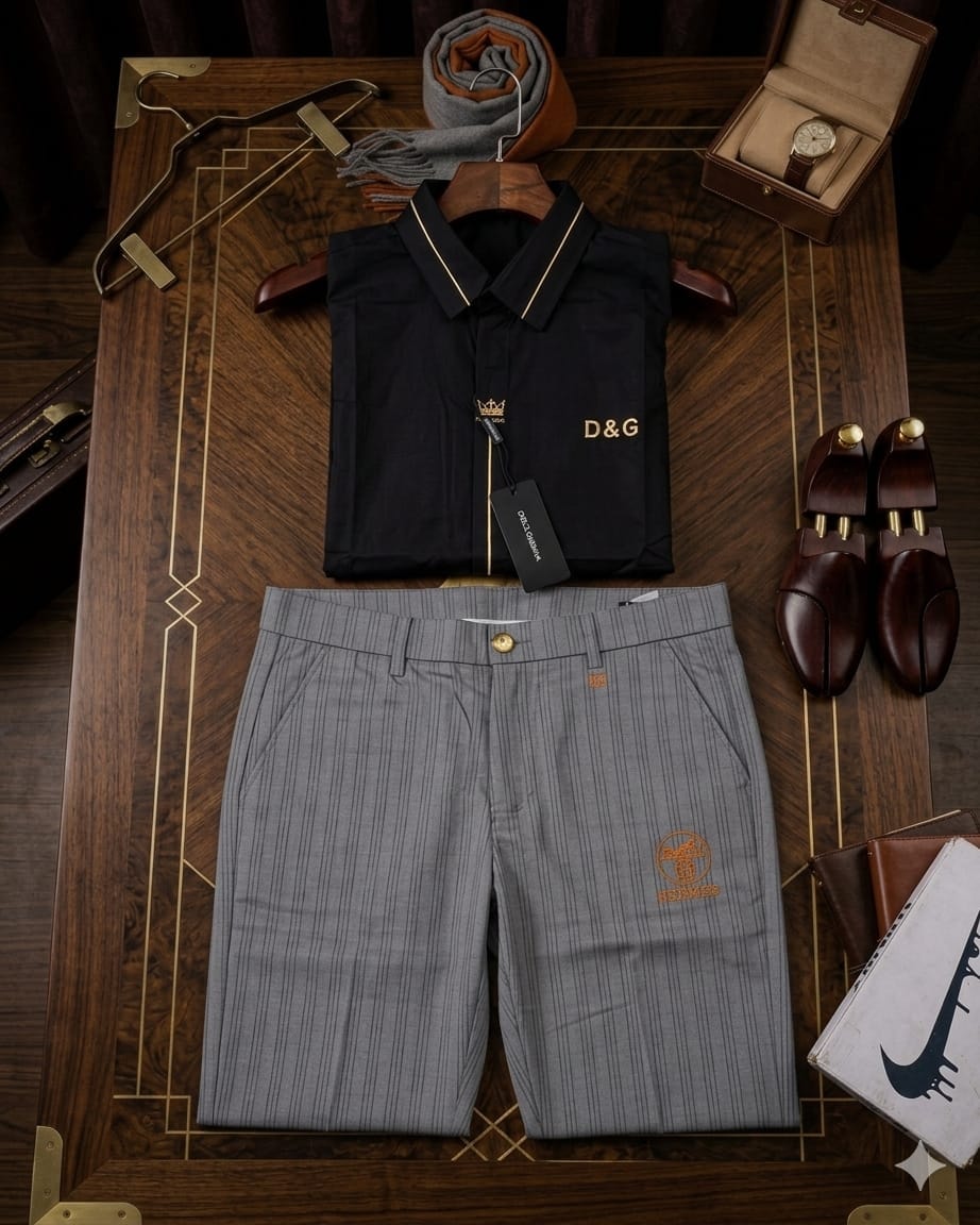 Black D&G sleeveless polo shirt with gray striped shorts arranged with shoes and accessories.