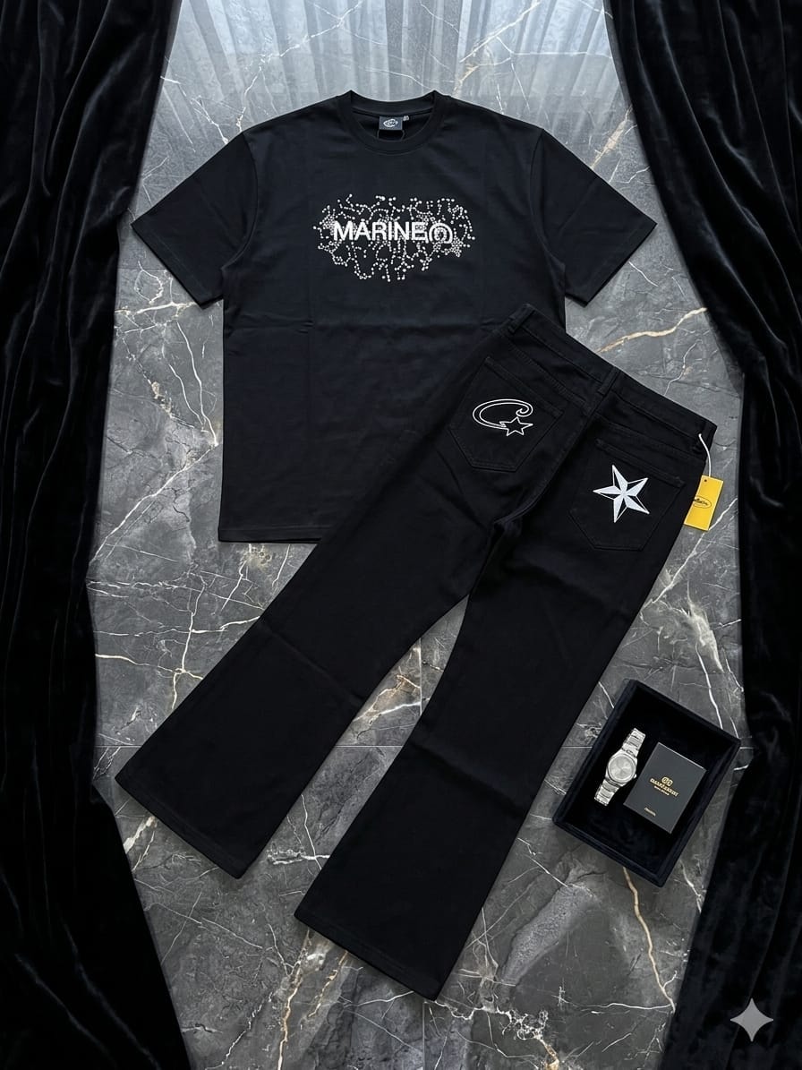 Black t-shirt with white beaded MARINE graphic paired with black flared trousers showing star embroidery on back pockets, styled on marble with accessories.