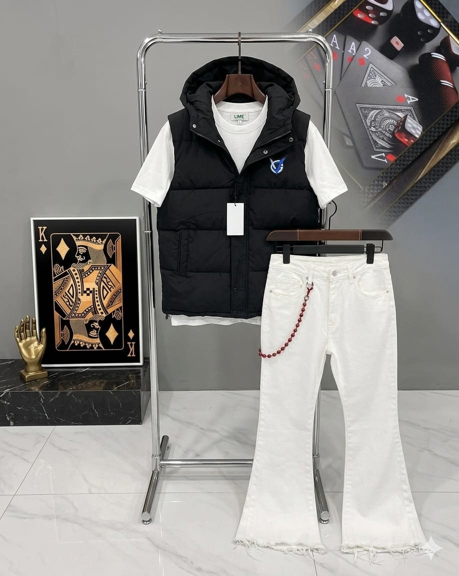 Black puffer vest, white tee and white flared jeans combo on display stand.