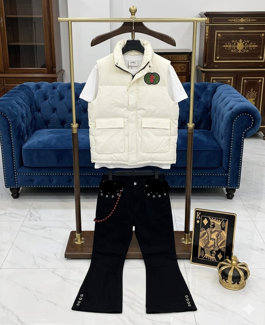 White puffer vest, white tee and black flared jeans combo on display stand.