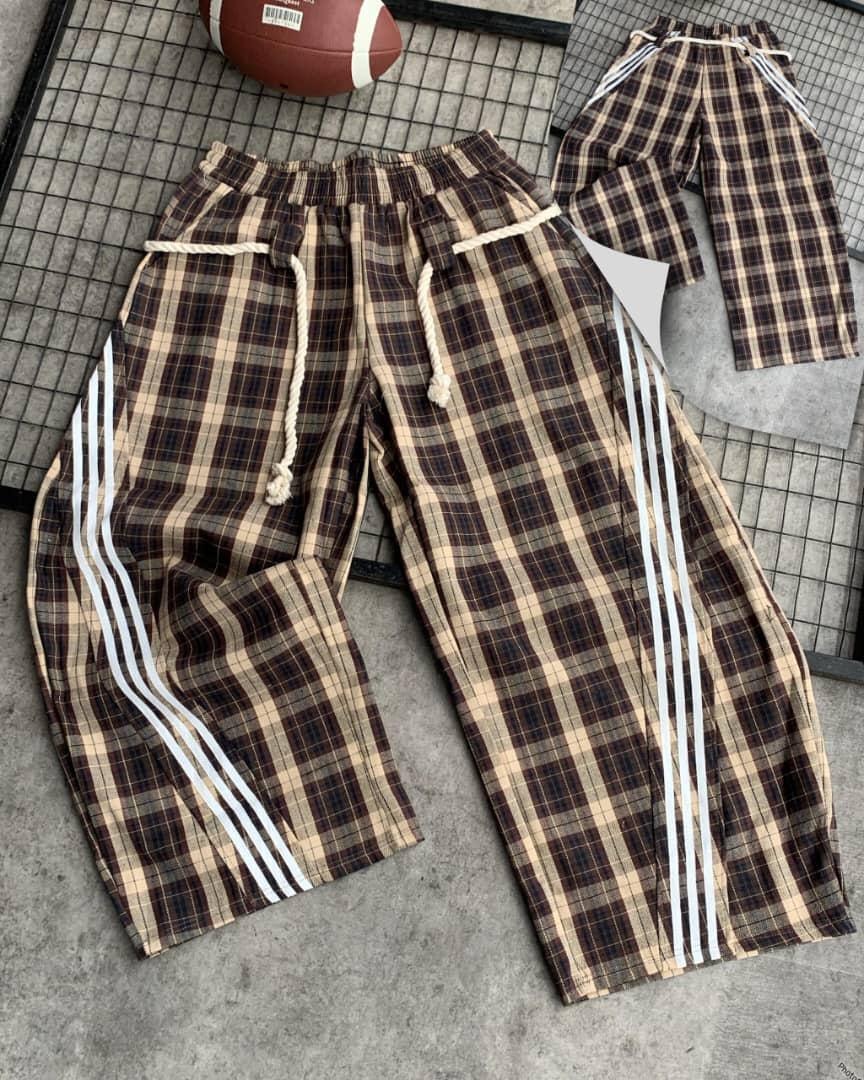 Brown plaid checkered joggers with thick white rope drawstring, elastic waist, and three white side stripes.