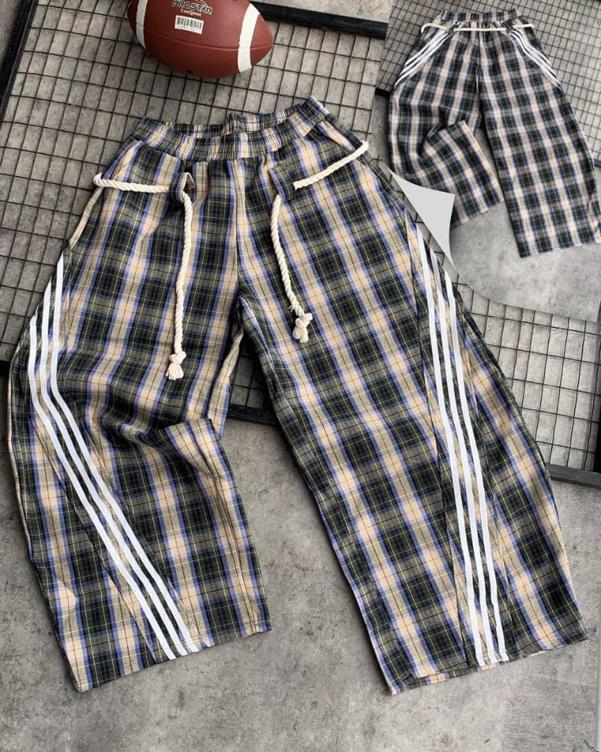 Green plaid checkered joggers with thick white rope drawstring, elastic waist, and three white side stripes.