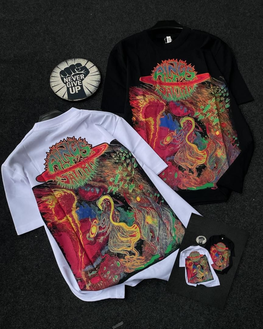 Black and white t-shirts with colorful psychedelic abstract graphic and text elements.