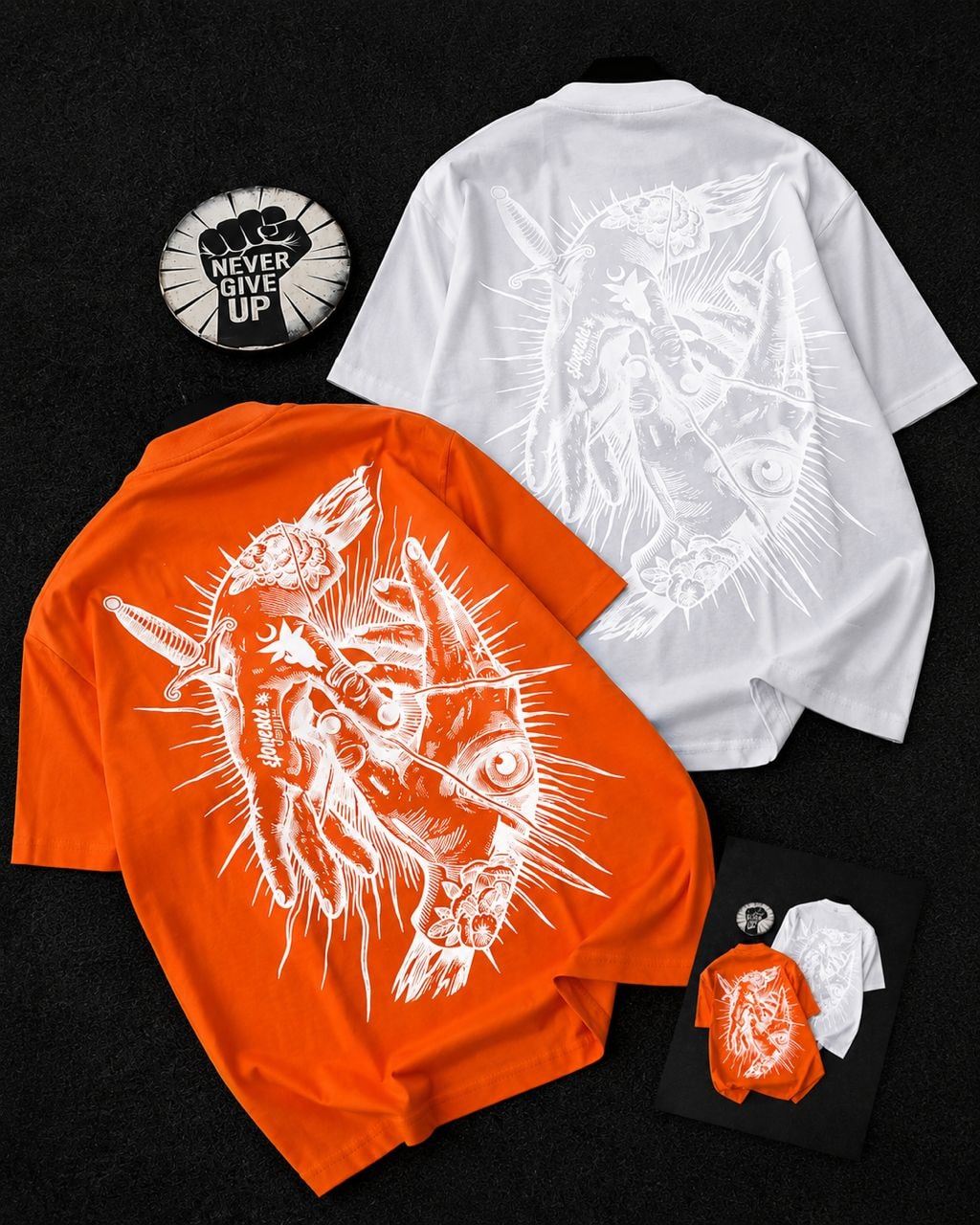 Orange and white t-shirts with detailed creature, eye, and sword graphic shown from multiple angles.