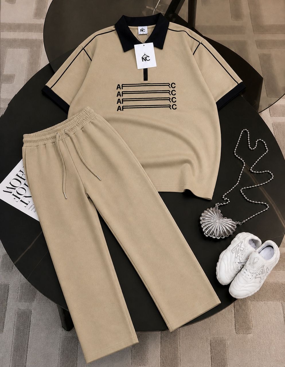 Beige AFRC polo shirt with black contrast trim and matching beige trousers.