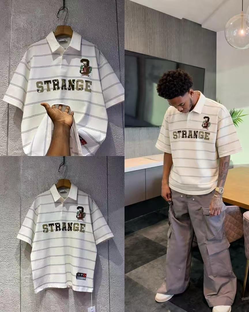 White striped polo shirt with STRANGE graphic and crest logo on hanger and model.