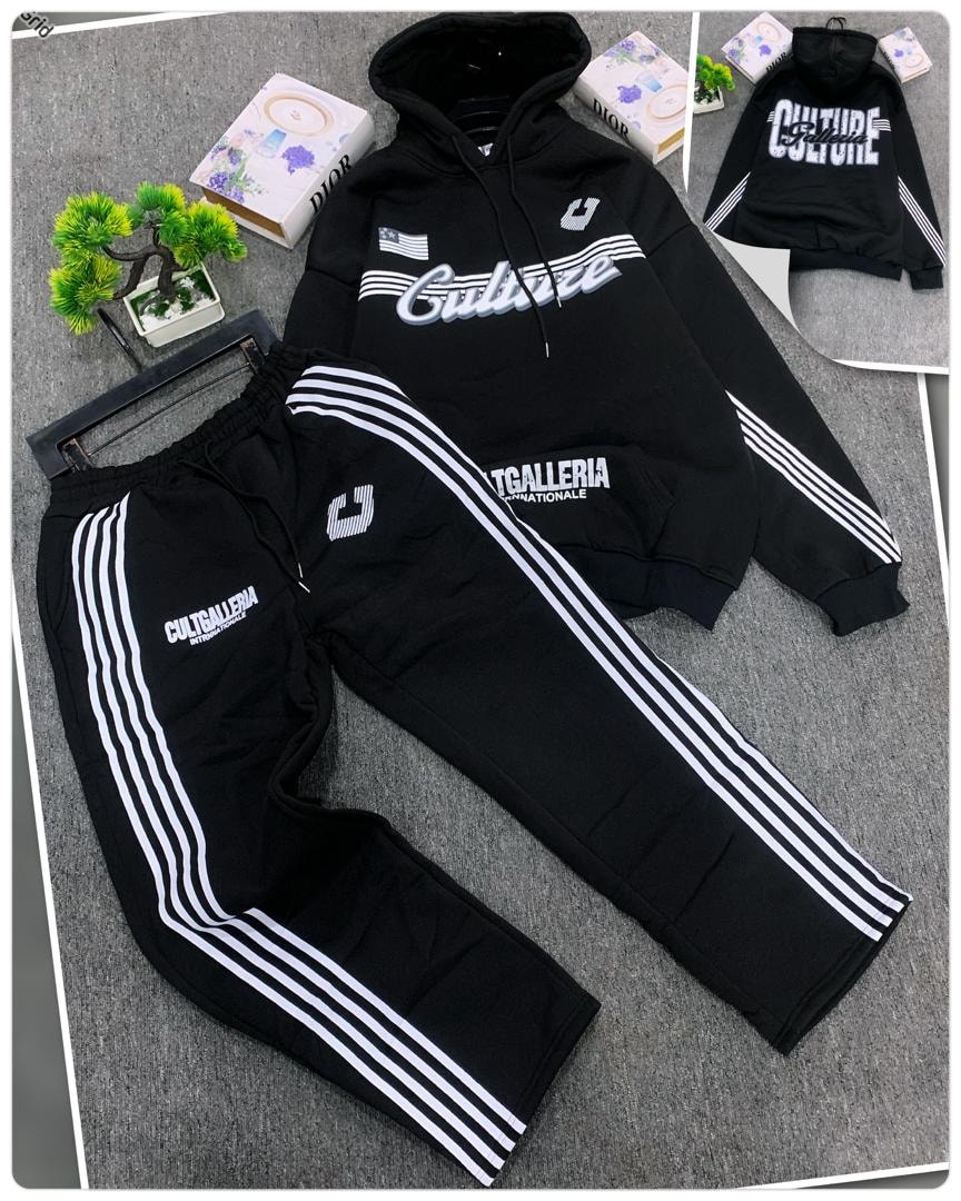Black oversized hoodie with Culture graphic and matching striped joggers.