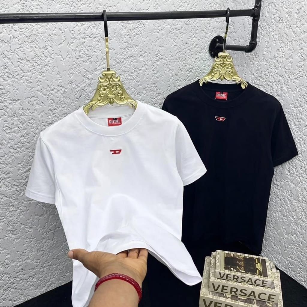 White and black Diesel t-shirts with red logo embroidery displayed side by side