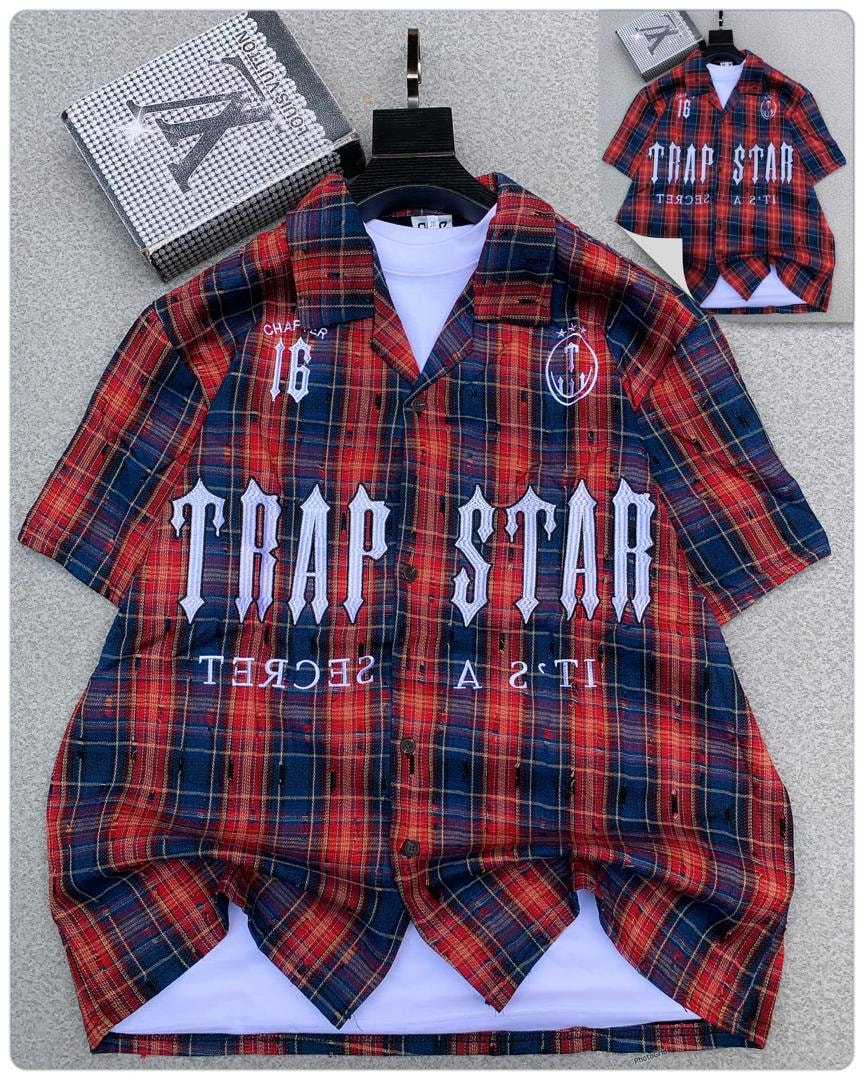 Red plaid Trapstar short sleeve shirt with large TRAP STAR embroidery over white tee.