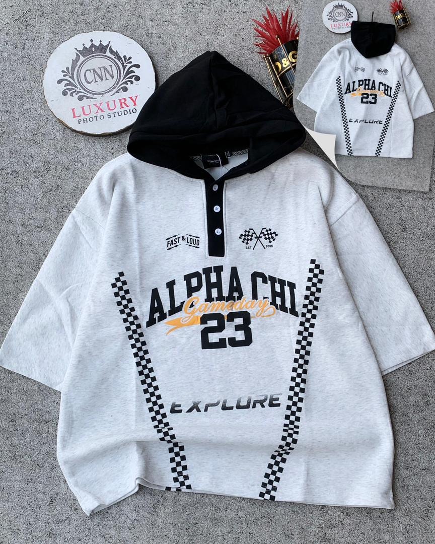 Light gray oversized hooded top with black hood, button placket, and ALPHA CHI 23 graphics with checkered patterns.