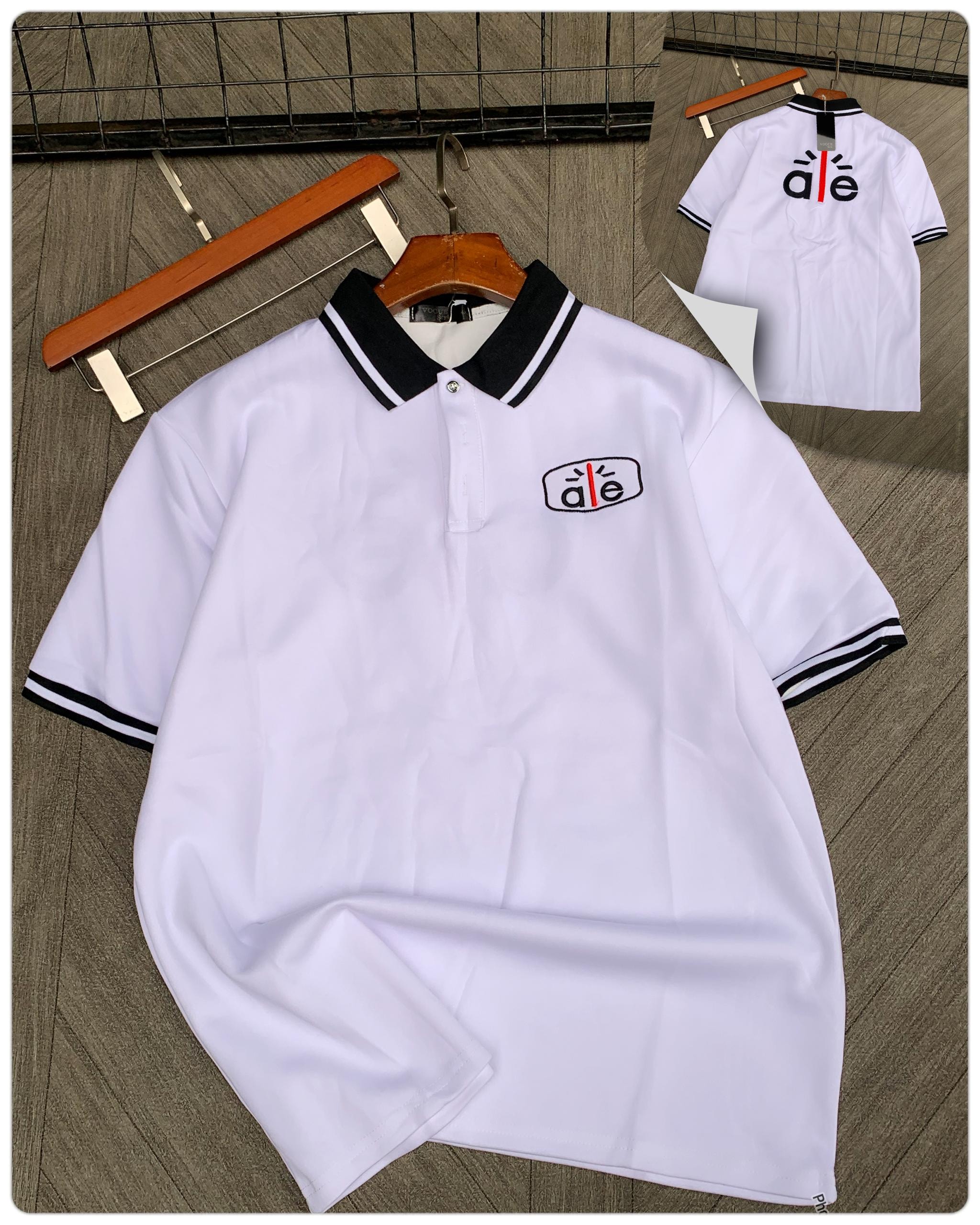 White short sleeve polo with contrast collar and a|e logo on chest.