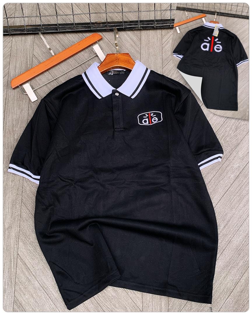 Black short sleeve polo with white striped collar and embroidered logo.