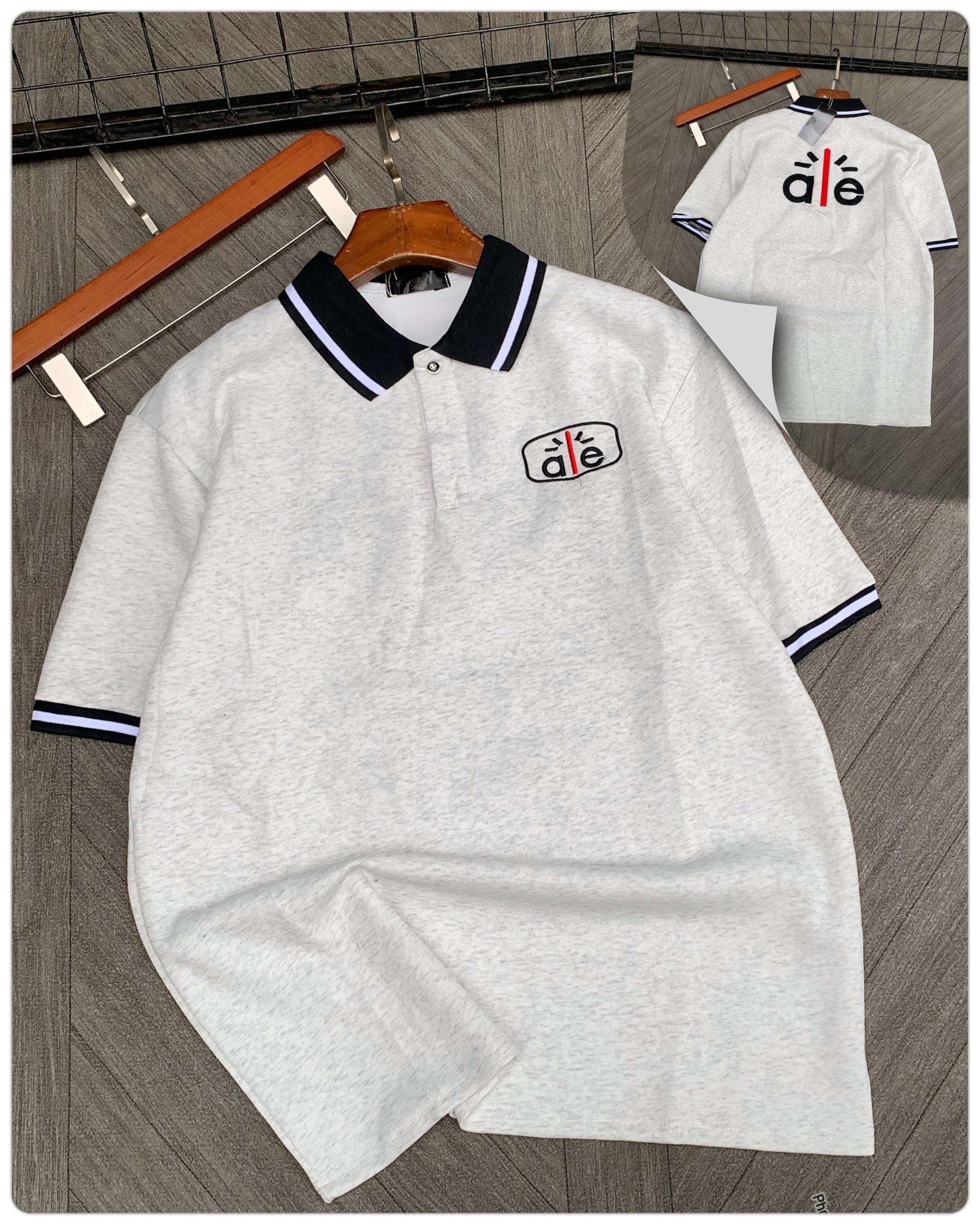 Gray short sleeve polo with contrast collar and embroidered logo.
