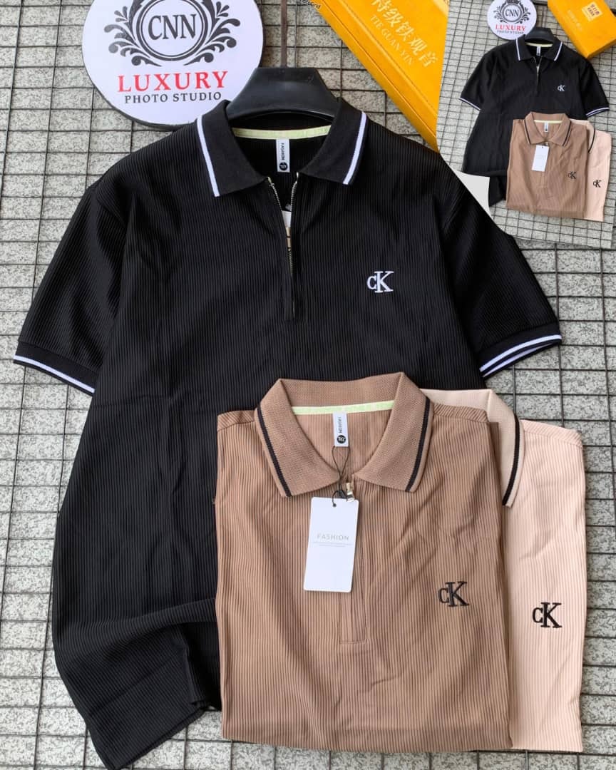Black, brown and beige CK ribbed zip collar polos displayed on tiled background with logo insets.