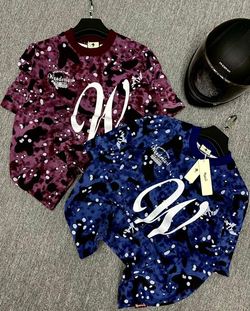 Purple and blue camo splatter t-shirts with large white W graphic and Wanderlust print.