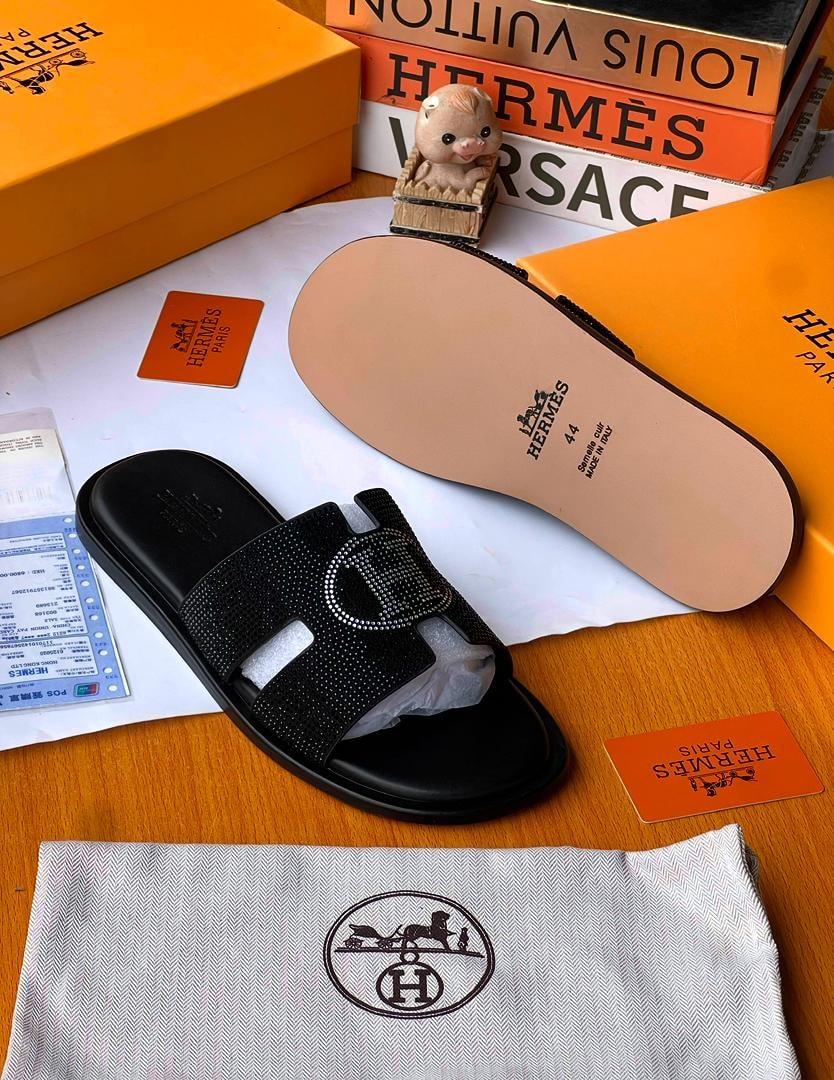 Black rhinestone Hermès slides in luxury box setup with dust bag and branding cards.