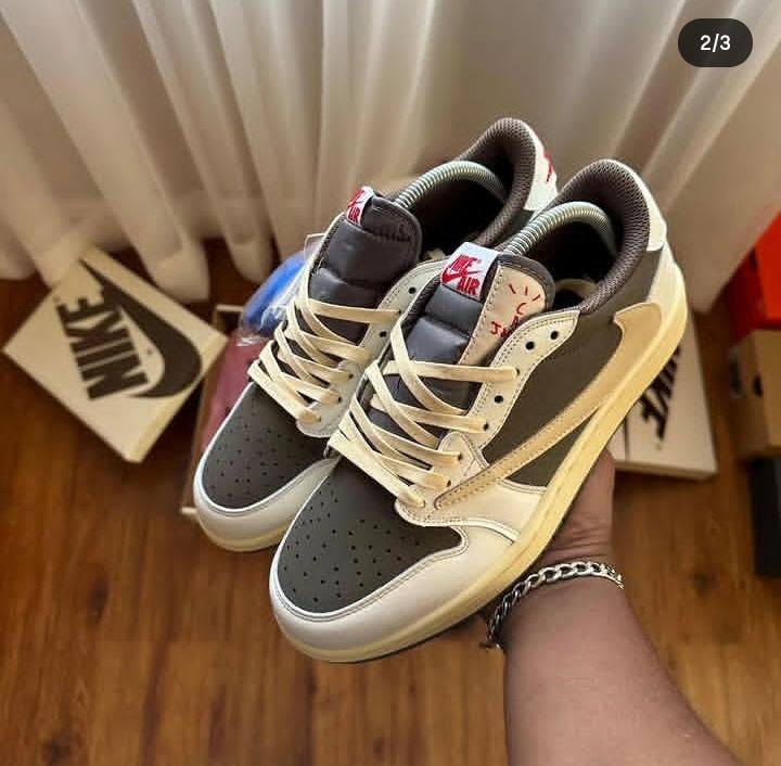 Nike Air low-top sneakers in grey, white and beige held in hand showing side and front profile