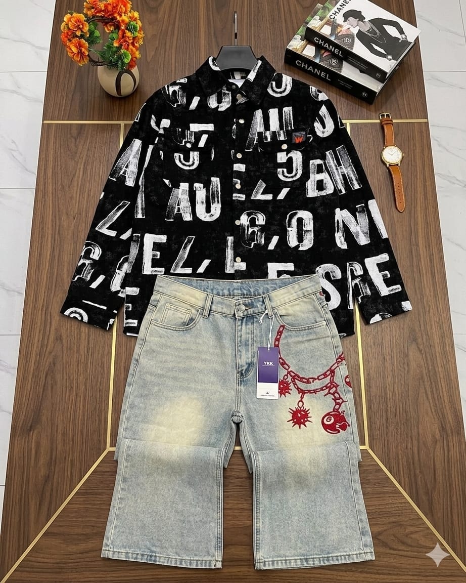 Black all-over letter print shirt with light blue denim shorts and red chain details on wooden table.