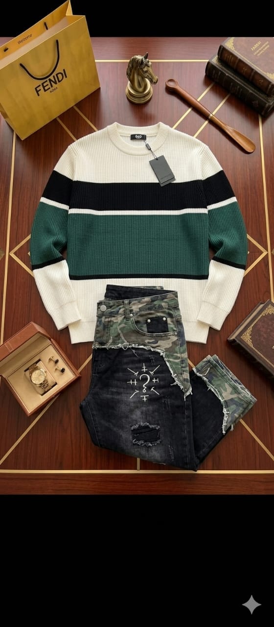 Striped green black and white knit sweater with camo ripped jeans styled on wooden surface with accessories.