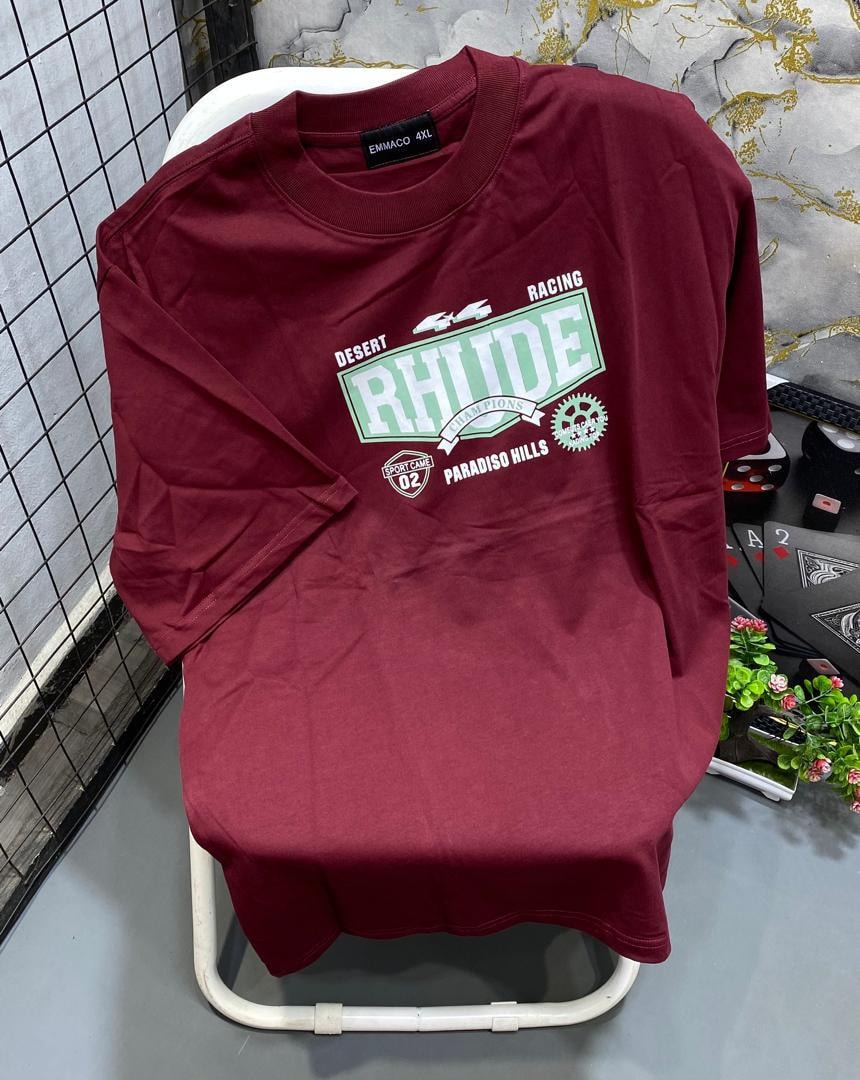 Maroon t-shirt with green and white Rhude racing graphic and text prints.