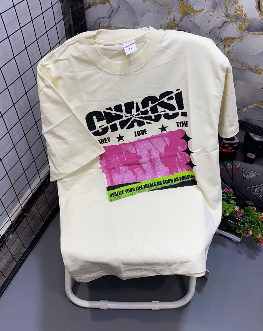 Cream t-shirt with black Chaos graphic, pink panel and motivational text.