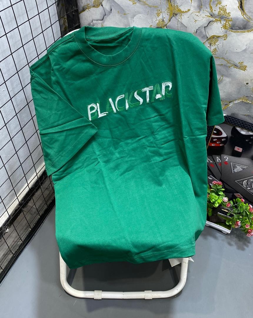 Green t-shirt with white and green stylized Blackstar text print.