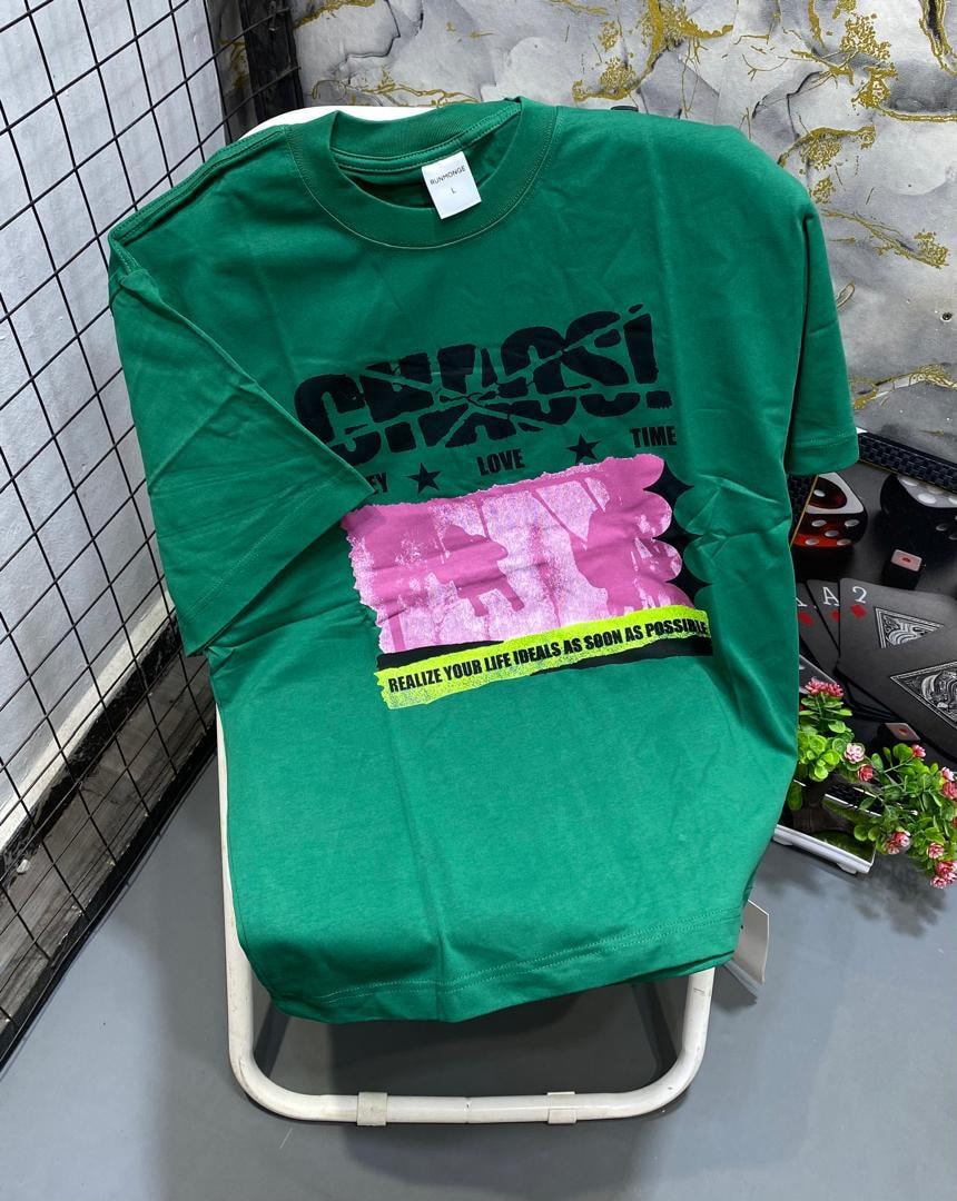 Green t-shirt with black Chaos graphic, pink panel and motivational text.