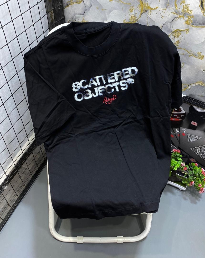 Black t-shirt with white SCATTERED OBJECTS text and red Always script.