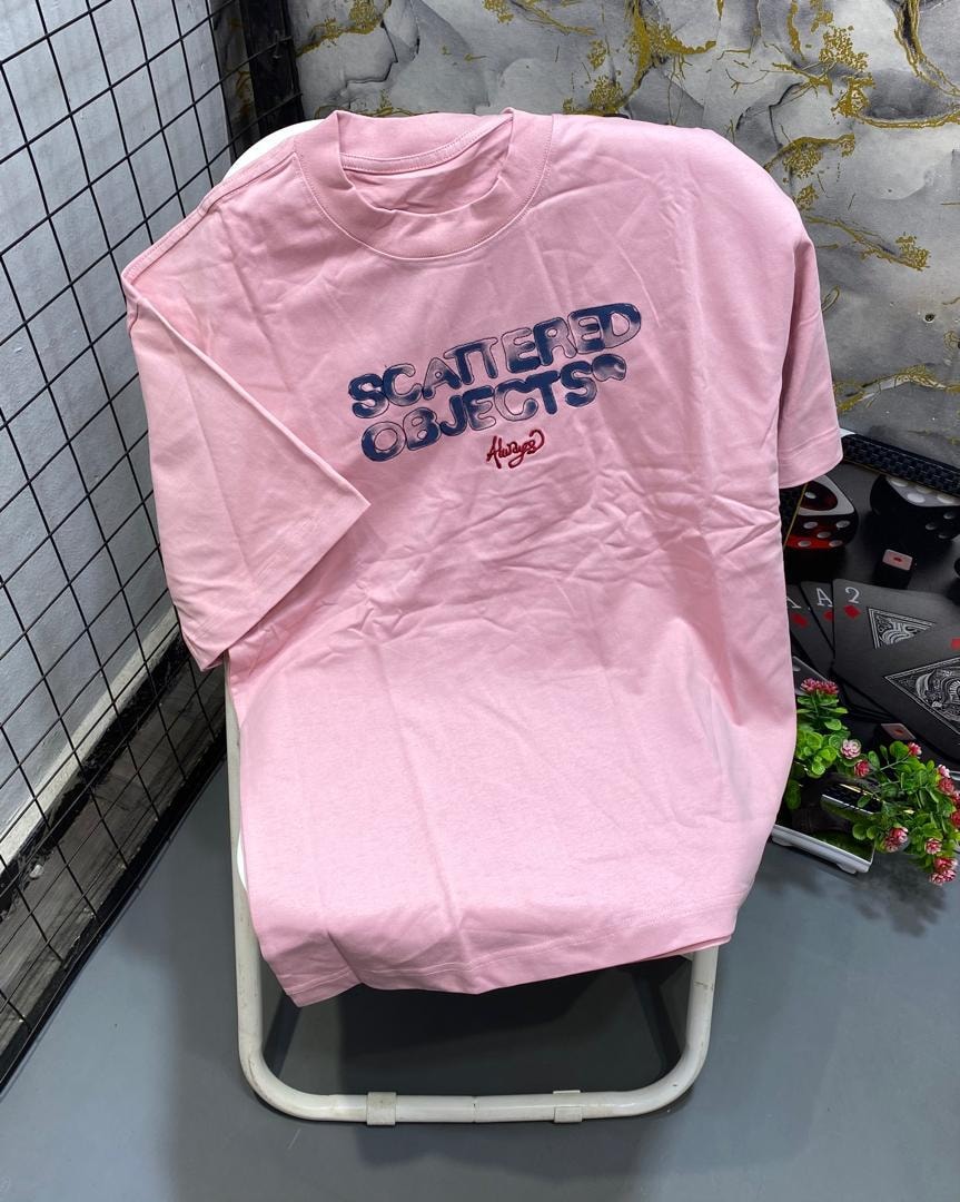 Pink t-shirt with blue SCATTERED OBJECTS text and red Always script.