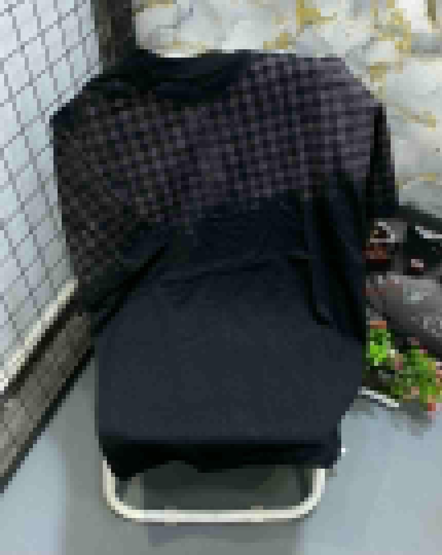 Black t-shirt with dark checkered pattern on upper portion and sleeves.
