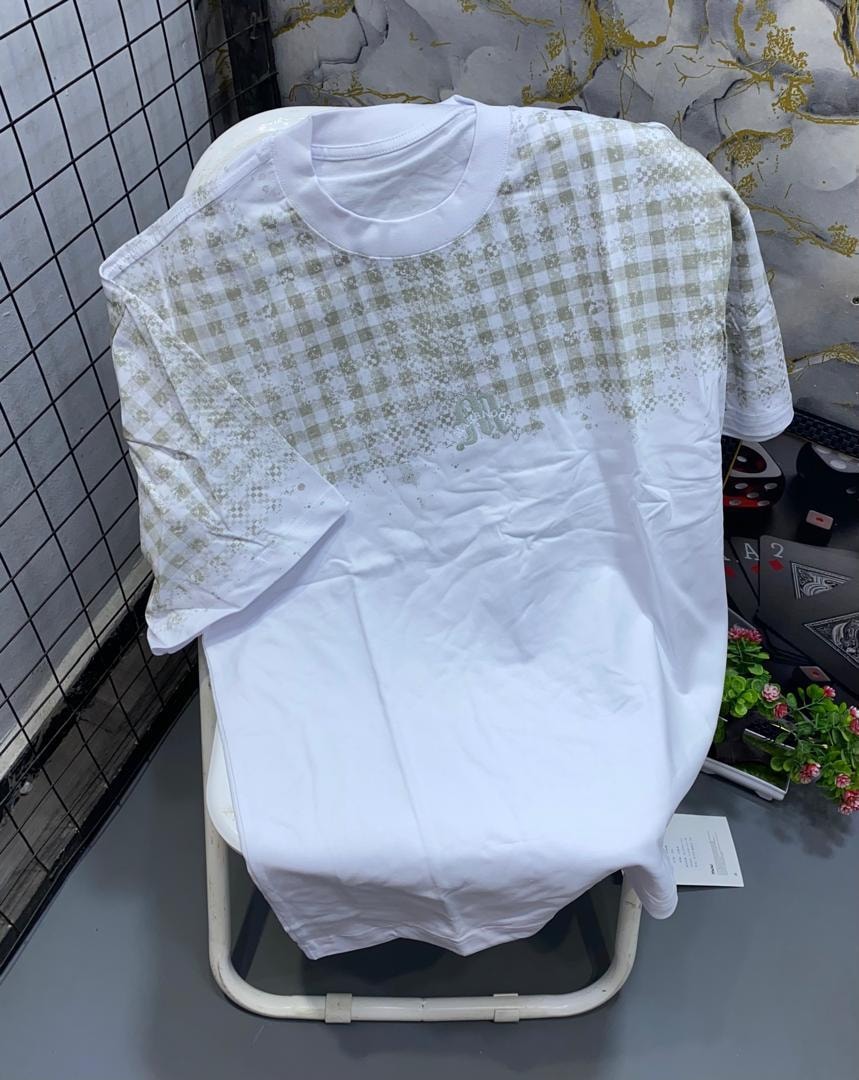 White t-shirt with green checkered pattern on upper body and small chest logo.