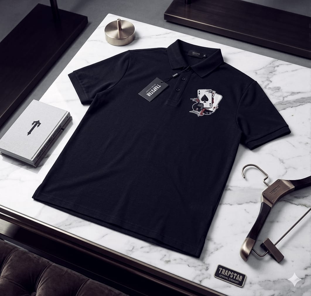 Black Trapstar polo shirt with playing cards graphic on chest.