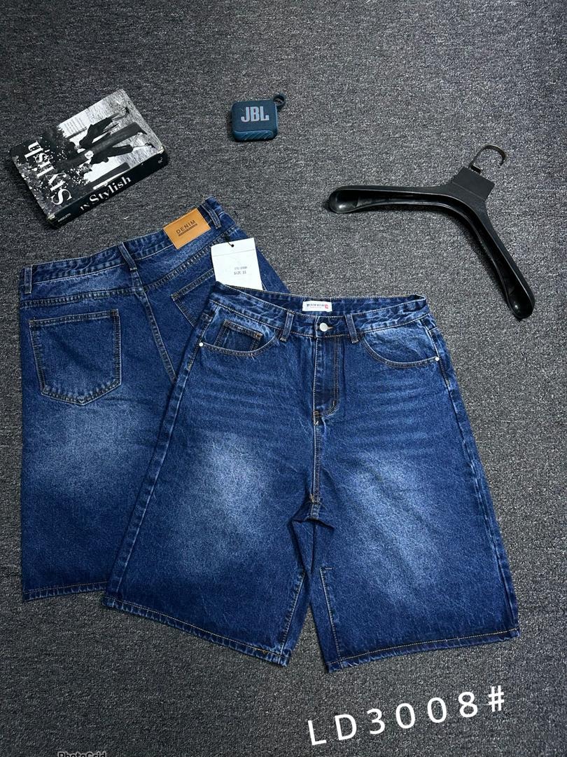 Clean blue denim shorts with front and back views on grey surface with accessories.