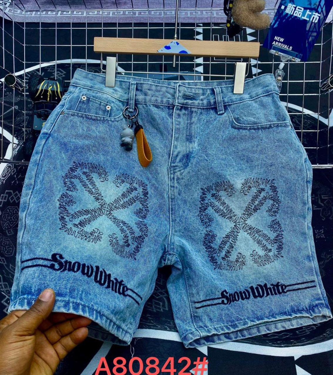 Light blue denim shorts with peace sign embroidery, Snow White text and back view.