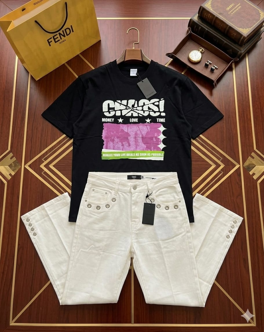 Black t-shirt with Chaos graphic and white eyelet shorts displayed flat on wooden surface with accessories.