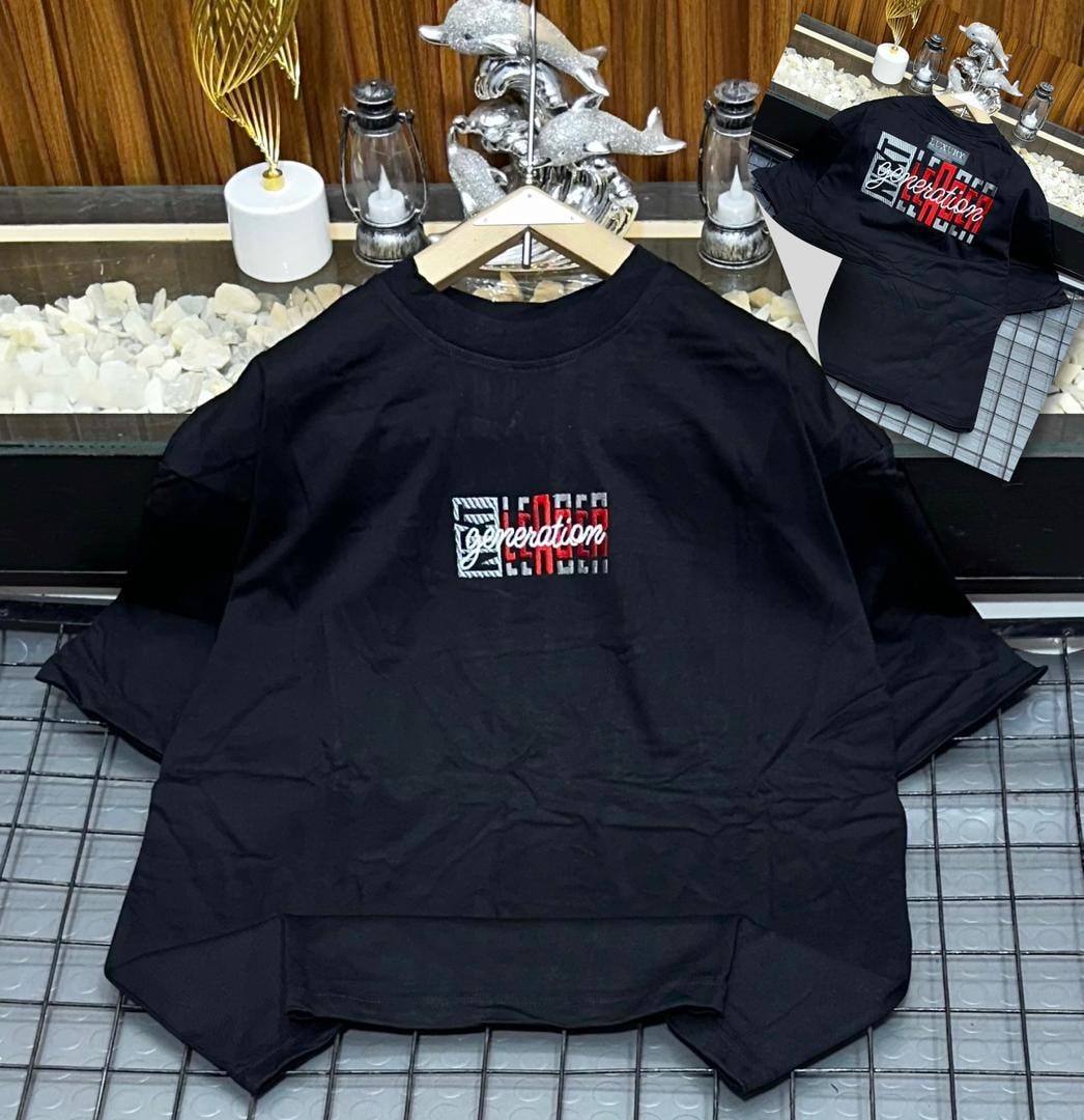 Black oversized polo shirt with generation embroidery on chest, shown on hanger with design inset.