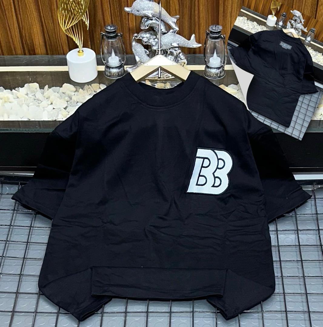 Black oversized polo shirt with BB embroidery on the chest, shown on hanger with back view inset.