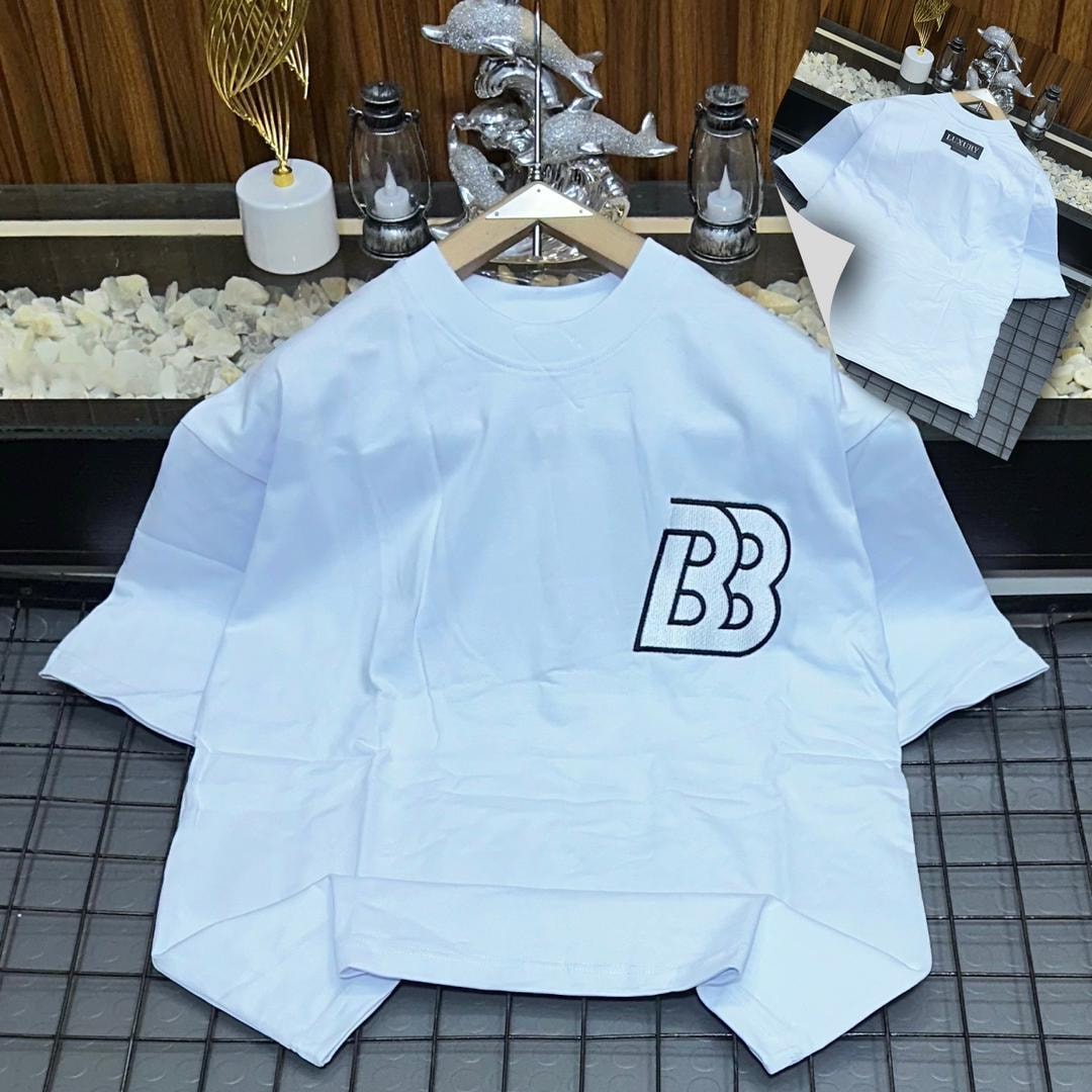 White oversized polo shirt with BB embroidery on the chest, shown on hanger with back view inset.