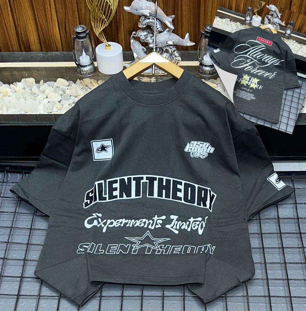 Black oversized polo displaying white Silent Theory prints across chest and arms.