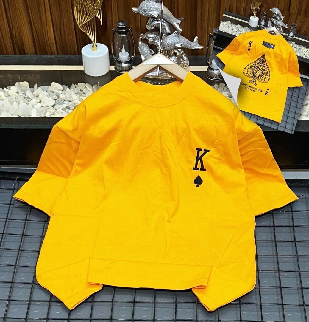Yellow oversized polo featuring K spade symbol on front with back view inset.