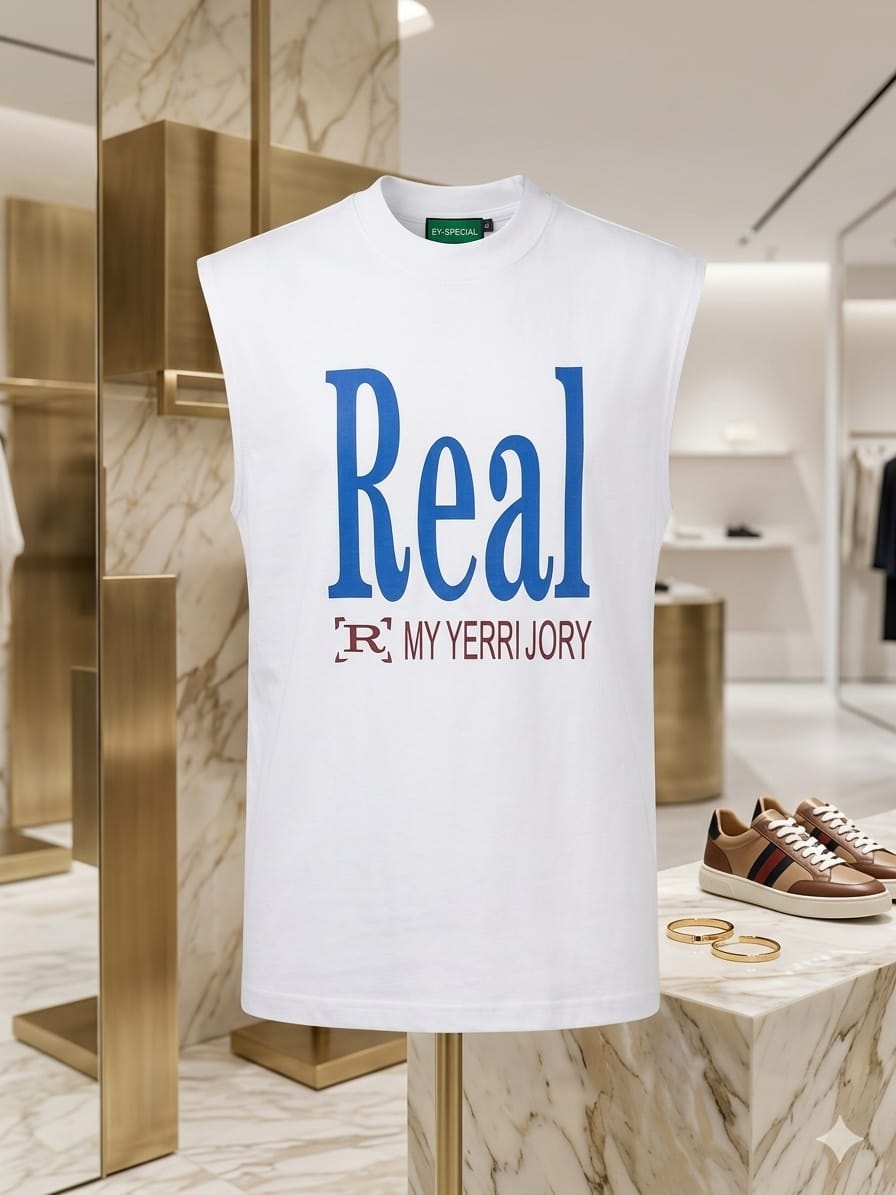 White sleeveless top with large blue Real text and MY YERRI JORY print.