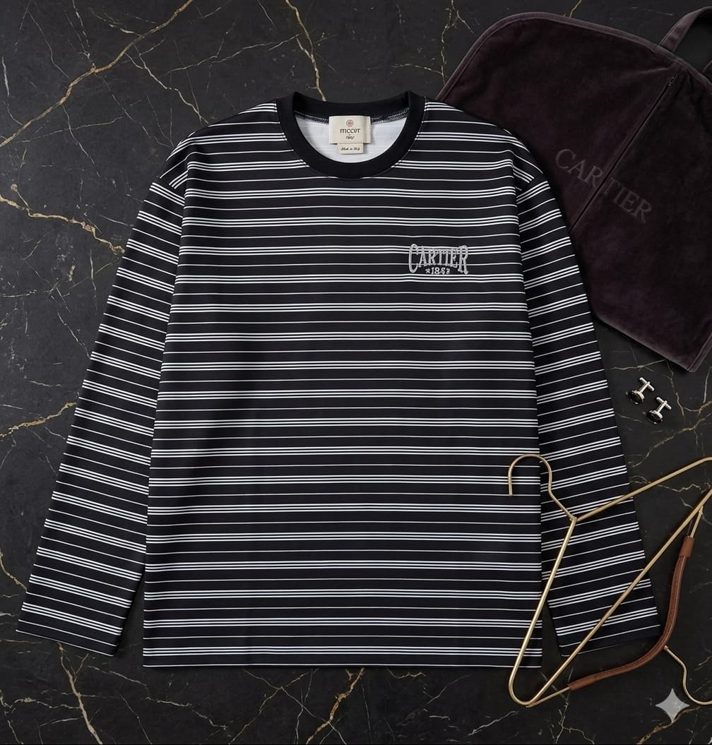 Black and white striped long-sleeve top with Cartier embroidery on left chest.