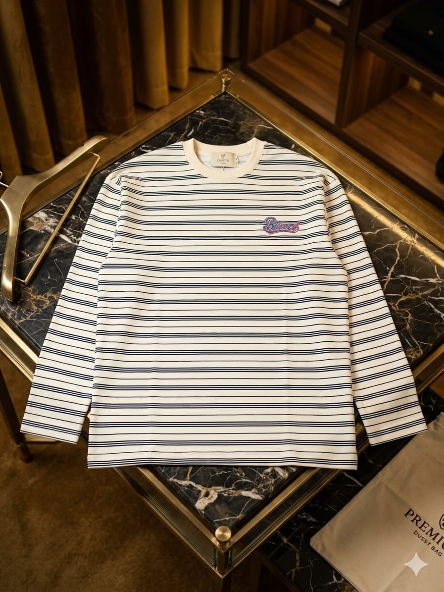 White and blue striped long-sleeve top with Blessed embroidery on left chest.