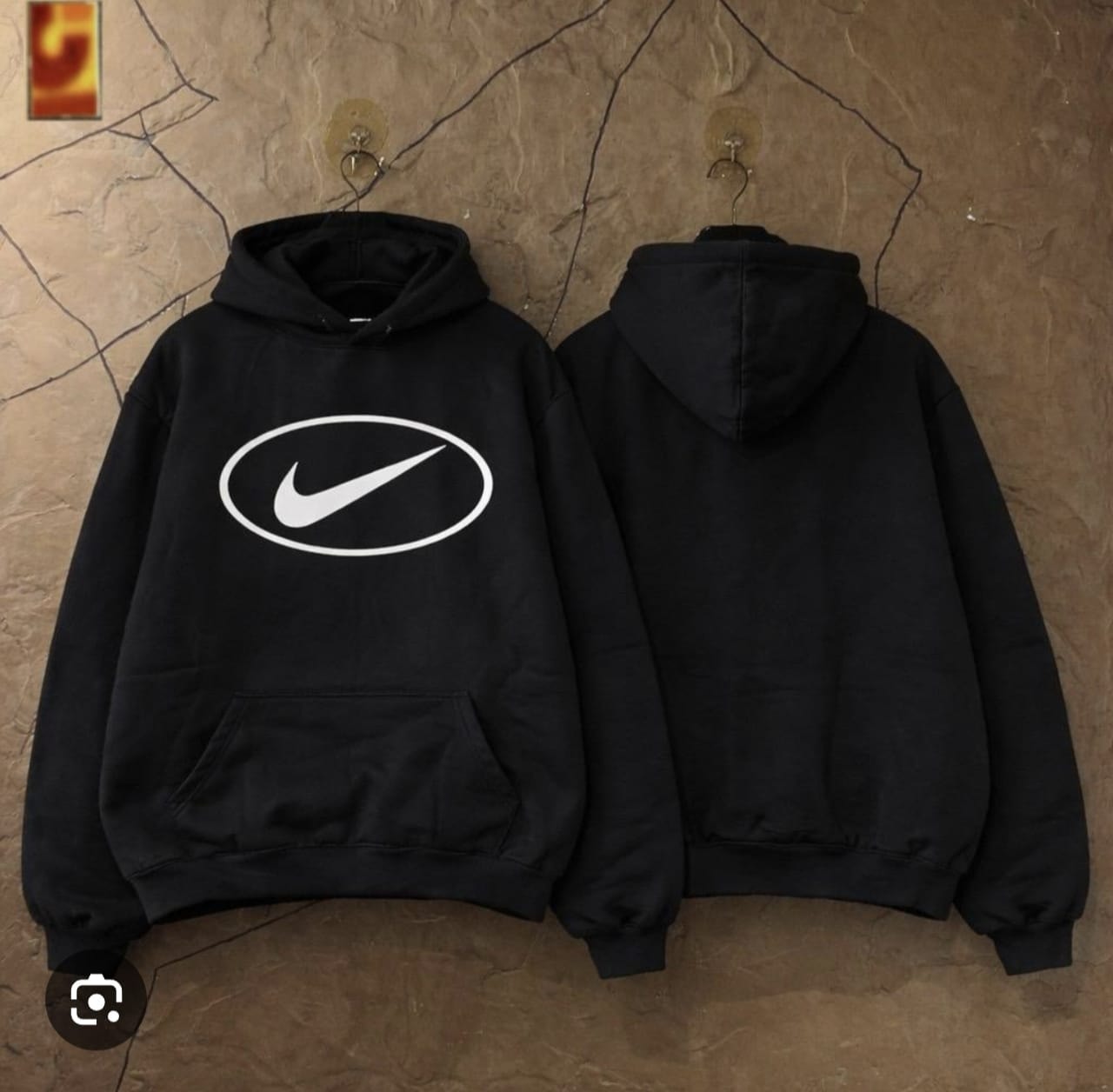 Black hoodie with white oval Nike logo displayed from front and back views.