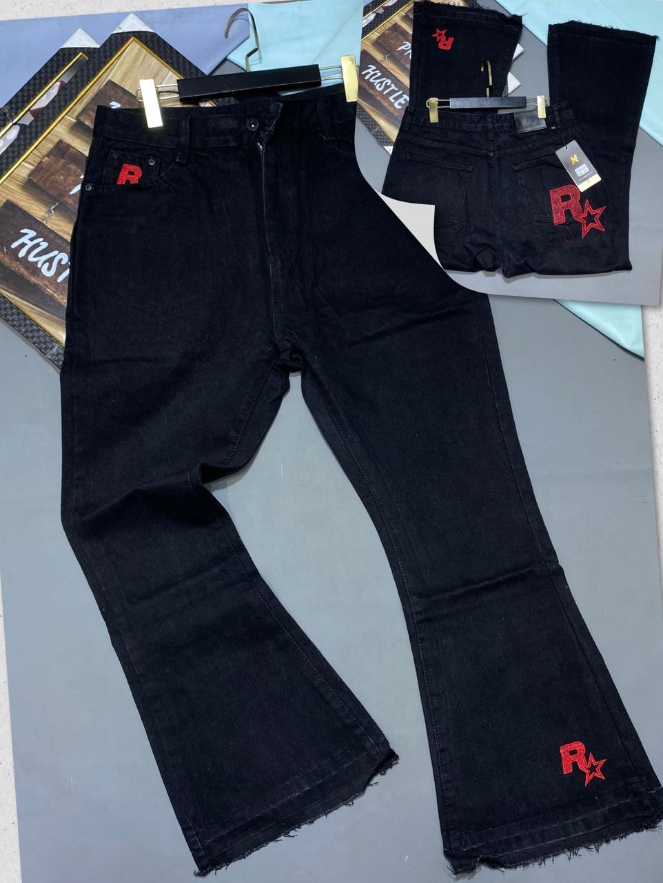Black baggy flared jeans with red R and star embroidery on back pocket and leg, shown from front and back angles.