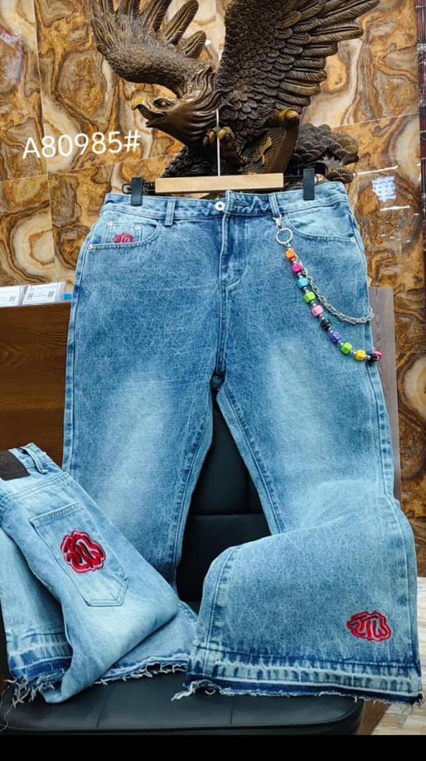 Blue baggy jeans with red rose embroidery, colorful beaded chain and flared legs.