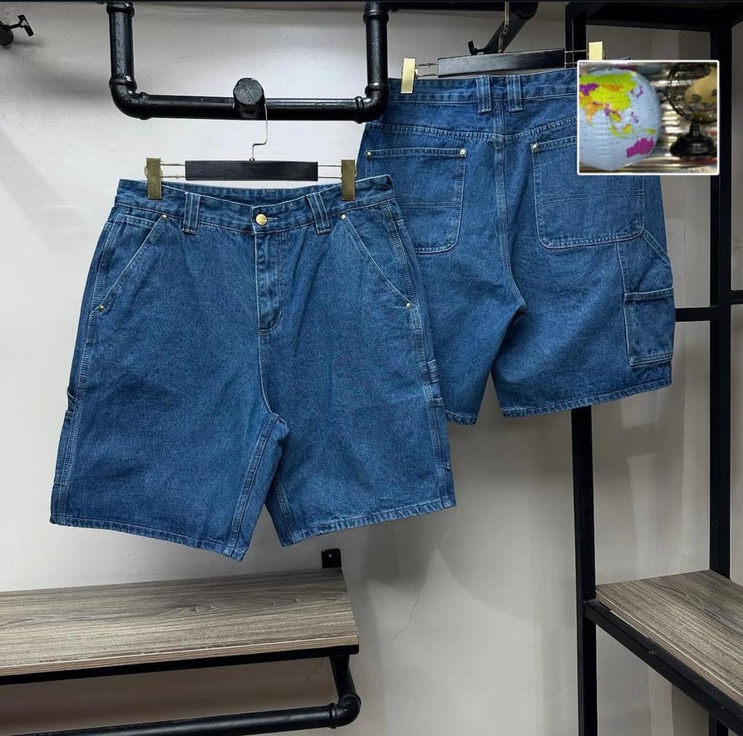 Blue denim cargo shorts hanging to display front and back with multiple pockets.