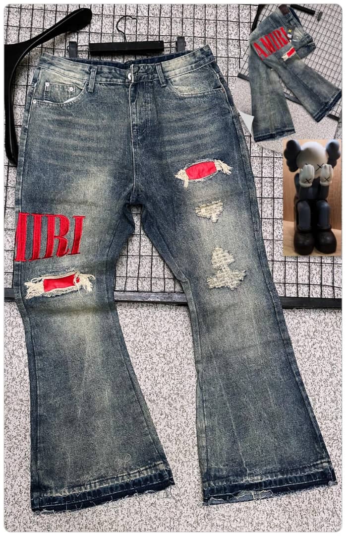 Distressed blue baggy jeans with large red AMIRI logo on leg, rips with red patches, and back view inset.